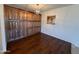 Cozy dining room showcasing dark wood floors and matching custom built-in storage at 3145 W Acoma Dr, Phoenix, AZ 85053