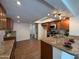 Modern kitchen featuring granite countertops, an island sink, and updated stainless steel appliances at 3145 W Acoma Dr, Phoenix, AZ 85053