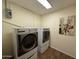 Laundry room featuring a washer and dryer, tile floors, and a decorative piece on the wall at 3145 W Acoma Dr, Phoenix, AZ 85053