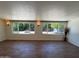 Bright living room featuring wood-look floors and large windows showcasing the outdoor space at 3145 W Acoma Dr, Phoenix, AZ 85053