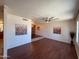Spacious living room featuring sleek hardwood floors, modern ceiling fan, and updated fixtures at 3145 W Acoma Dr, Phoenix, AZ 85053