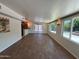 Open-concept living room featuring updated floors and abundant natural light from large windows at 3145 W Acoma Dr, Phoenix, AZ 85053