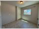 Room featuring tile floors, a window, and a door leading to the exterior at 3145 W Acoma Dr, Phoenix, AZ 85053