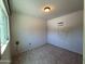 Room featuring tile floors, a window, a light fixture, and an air conditioning unit at 3145 W Acoma Dr, Phoenix, AZ 85053