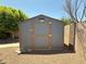 Outdoor shed with a secure door and ample storage space in a well-maintained backyard setting at 3145 W Acoma Dr, Phoenix, AZ 85053