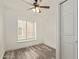 Bedroom with a window, ceiling fan, and wood-look floors at 3350 W Las Palmaritas Dr, Phoenix, AZ 85051