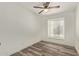 Cozy bedroom with wood-look floors, a window, and white walls at 3350 W Las Palmaritas Dr, Phoenix, AZ 85051