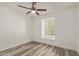 Bedroom with wood-look floors, a window, and a ceiling fan at 3350 W Las Palmaritas Dr, Phoenix, AZ 85051