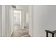Bright hallway with wood-look floors leading to bedrooms with white doors at 3350 W Las Palmaritas Dr, Phoenix, AZ 85051