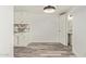 Kitchenette with white cabinetry, granite countertops, and laminate flooring at 3350 W Las Palmaritas Dr, Phoenix, AZ 85051