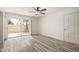 The living room features modern laminate flooring, a ceiling fan, and a sliding glass door at 3350 W Las Palmaritas Dr, Phoenix, AZ 85051