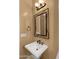 Charming powder room with pedestal sink, decorative mirror, and gold fixtures at 36813 N 109Th Way, Scottsdale, AZ 85262