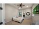 Comfortable bedroom with TV, ceiling fan, tile floors and ensuite bath at 36813 N 109Th Way, Scottsdale, AZ 85262