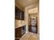 Butler's pantry with wine refrigerator, hardwood floors, and neutral paint at 36813 N 109Th Way, Scottsdale, AZ 85262