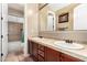 Bathroom with dual sinks, dark wood cabinets, tile countertops, and a shower/tub combo at 4041 N Silver Ridge Cir, Mesa, AZ 85207
