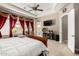 This spacious bedroom boasts a ceiling fan, pool access, and large windows draped with decorative curtains at 4041 N Silver Ridge Cir, Mesa, AZ 85207