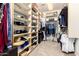 Walk-in closet with ample storage space, shelving, and hanging rods for clothes and accessories at 4041 N Silver Ridge Cir, Mesa, AZ 85207