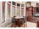Cozy dining area with a round table, seating for four, and natural light from large windows at 4041 N Silver Ridge Cir, Mesa, AZ 85207