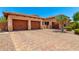 Beautiful home featuring stone accents, desert landscaping, a two-car garage and brick driveway at 4041 N Silver Ridge Cir, Mesa, AZ 85207