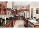 Stylish kitchen with dark cabinets, granite countertops, stainless steel appliances, and tiled flooring at 4041 N Silver Ridge Cir, Mesa, AZ 85207