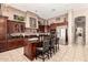 Gourmet kitchen with dark wood cabinets, a center island, granite countertops, and stainless steel appliances at 4041 N Silver Ridge Cir, Mesa, AZ 85207