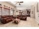 Open living space featuring comfortable leather seating, tiled floors, and views into the kitchen at 4041 N Silver Ridge Cir, Mesa, AZ 85207