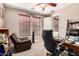 Home office/den featuring dark wood accents, chair, two windows, and a comfortable leather recliner at 4041 N Silver Ridge Cir, Mesa, AZ 85207
