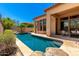 Beautiful pool view with stone waterfall feature in a private backyard with desert landscaping at 4041 N Silver Ridge Cir, Mesa, AZ 85207