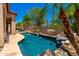 Landscaped backyard featuring a sparkling pool, palm trees, and plenty of space for entertaining at 4041 N Silver Ridge Cir, Mesa, AZ 85207