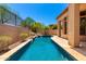 Backyard view of a rectangular pool lined with stone and surrounded by desert landscaping at 4041 N Silver Ridge Cir, Mesa, AZ 85207