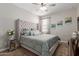 Cozy bedroom featuring a comfortable bed, a ceiling fan, and natural light streaming through the curtains at 4108 N 304Th Ln, Buckeye, AZ 85396