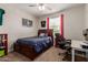Bedroom with a bed, ceiling fan, and natural light streaming through the window at 4108 N 304Th Ln, Buckeye, AZ 85396