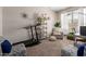 Versatile bonus room featuring neutral walls, a treadmill, and comfortable seating, flooded with natural light at 4108 N 304Th Ln, Buckeye, AZ 85396