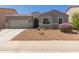 Charming single-story home with a well-manicured front yard and a two-car garage at 4108 N 304Th Ln, Buckeye, AZ 85396