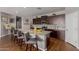 Modern kitchen featuring a large granite island with seating, dark wood cabinets, and stainless steel appliances at 4108 N 304Th Ln, Buckeye, AZ 85396