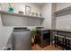 Well-organized laundry room equipped with modern washer and dryer, ample shelving, and a folding counter at 4108 N 304Th Ln, Buckeye, AZ 85396