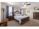 Serene main bedroom featuring a ceiling fan, carpet flooring, a large bed, and decoratively framed wall art at 4108 N 304Th Ln, Buckeye, AZ 85396