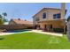 Expansive backyard featuring a pool, artificial grass, and a covered patio at 4514 E Verbena Dr, Phoenix, AZ 85044