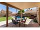 Outdoor patio area with a table and chairs overlooking the private backyard pool at 4514 E Verbena Dr, Phoenix, AZ 85044