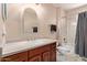 Bathroom featuring a single sink vanity, toilet, tub and shower combination, and a mirror at 4514 E Verbena Dr, Phoenix, AZ 85044