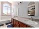 Bright bathroom with double sinks, tub, and a large window, offering natural light at 4514 E Verbena Dr, Phoenix, AZ 85044