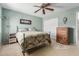 Cozy bedroom featuring a metal bed frame, ceiling fan and neutral tones at 4514 E Verbena Dr, Phoenix, AZ 85044