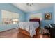 Bright bedroom with vaulted ceiling, wood floors, and natural light at 4514 E Verbena Dr, Phoenix, AZ 85044
