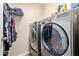 Modern laundry room with stainless steel washer and dryer, and plenty of storage at 4514 E Verbena Dr, Phoenix, AZ 85044