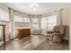 Comfortable living room with wood-look floors, recliner, window with blinds and built-in cabinet at 4514 E Verbena Dr, Phoenix, AZ 85044