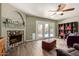 Comfortable living room with a stone fireplace and double doors leading to the pool at 4514 E Verbena Dr, Phoenix, AZ 85044