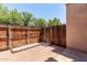 Private backyard with a brick patio surrounded by a wood fence and green foliage at 4901 E Kelton Ln # 1251, Scottsdale, AZ 85254