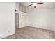 Bedroom features a neutral carpet, a ceiling fan, and a large closet at 4901 E Kelton Ln # 1251, Scottsdale, AZ 85254