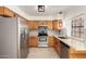 Bright kitchen features stainless steel appliances, granite countertops and wooden cabinetry at 4901 E Kelton Ln # 1251, Scottsdale, AZ 85254