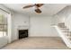 Bright living room with a fireplace, ceiling fan, wood floors, and a staircase at 4901 E Kelton Ln # 1251, Scottsdale, AZ 85254